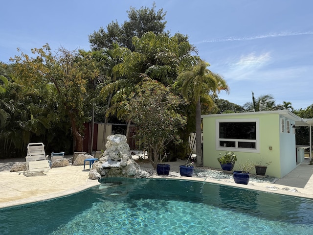 view of pool with a patio area, a fenced in pool, and fence