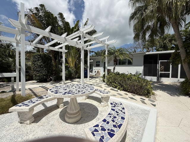 view of patio with a sunroom and a pergola