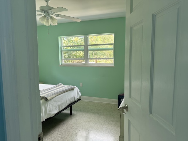 bedroom featuring ceiling fan and baseboards