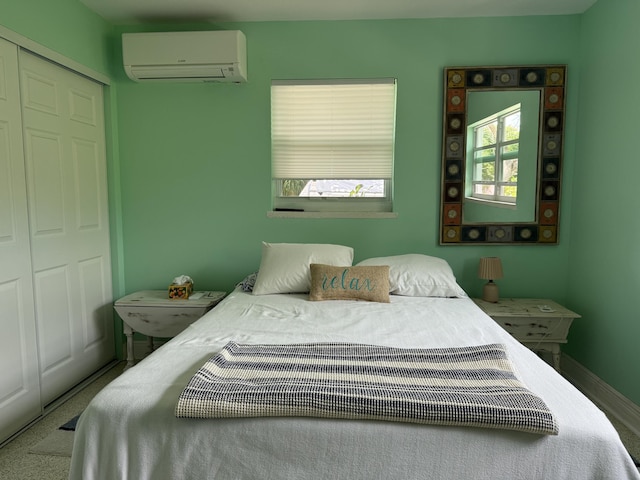 carpeted bedroom with baseboards, a closet, and an AC wall unit