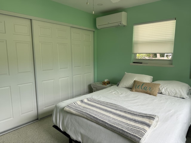 bedroom featuring a closet and a wall unit AC