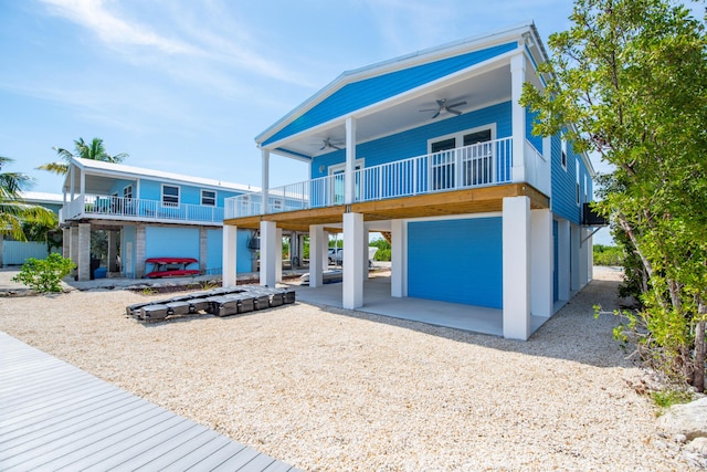 coastal home featuring ceiling fan and a carport