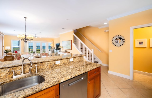 kitchen featuring decorative light fixtures, stainless steel dishwasher, ornamental molding, a sink, and light stone countertops