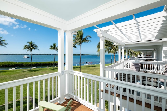 sunroom featuring a water view