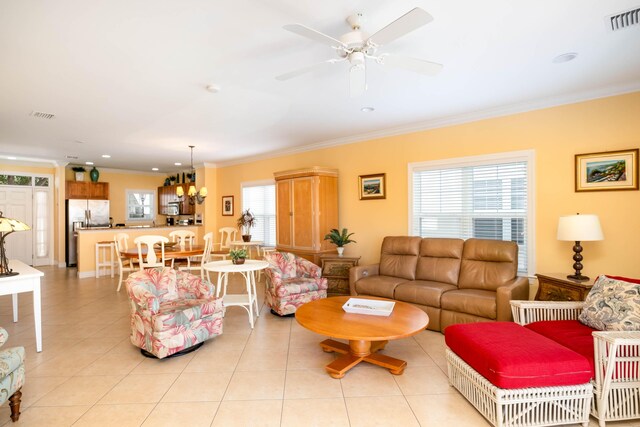 living room featuring a ceiling fan, visible vents, crown molding, and light tile patterned floors