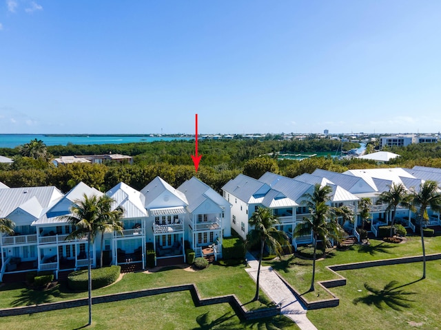 drone / aerial view featuring a water view and a residential view