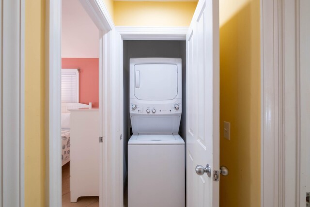 laundry room with stacked washer and dryer and laundry area