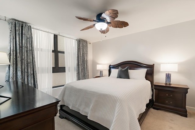 bedroom with light colored carpet and a ceiling fan