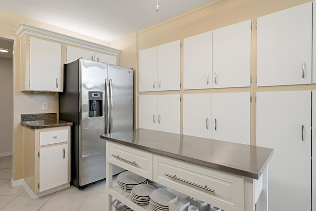 kitchen featuring stainless steel fridge with ice dispenser and light tile patterned floors