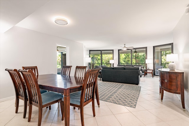 dining room with plenty of natural light, baseboards, light tile patterned floors, and a ceiling fan
