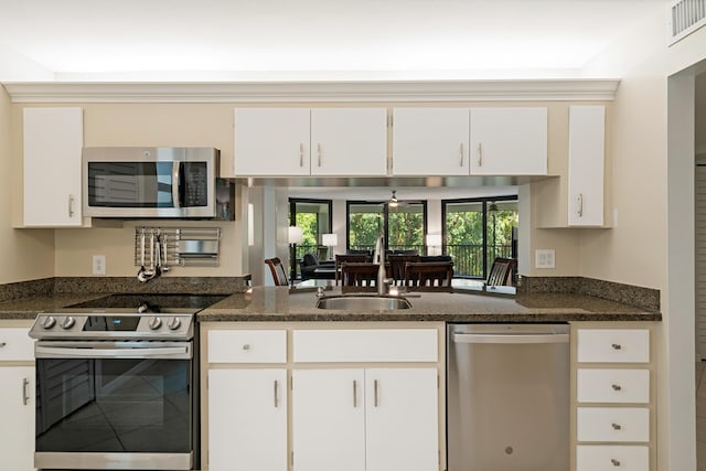kitchen with a sink, appliances with stainless steel finishes, visible vents, white cabinets, and ceiling fan