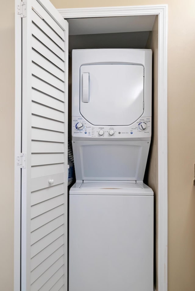 laundry room featuring stacked washer and clothes dryer and laundry area