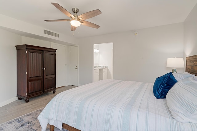 bedroom with light wood-style flooring, baseboards, ensuite bath, visible vents, and a ceiling fan