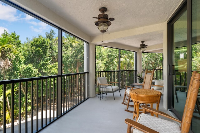 sunroom featuring ceiling fan