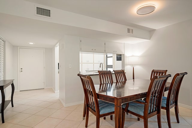 dining space featuring light tile patterned flooring, baseboards, and visible vents