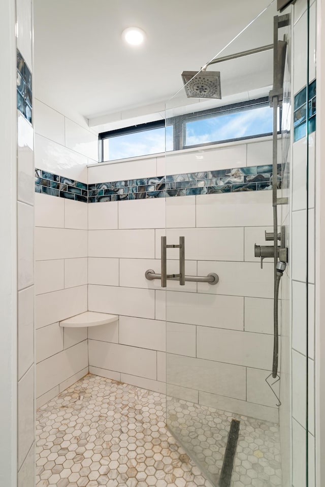 bathroom featuring a tile shower and visible vents