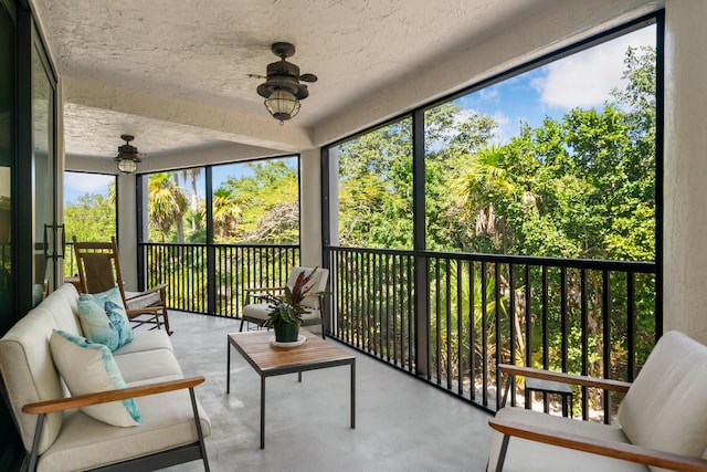 sunroom featuring plenty of natural light, ceiling fan, and outdoor lounge area