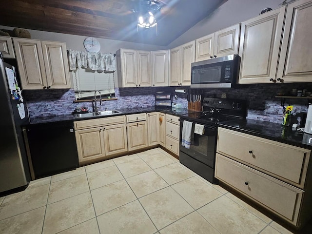 kitchen with light tile patterned floors, dark countertops, vaulted ceiling, a sink, and black appliances