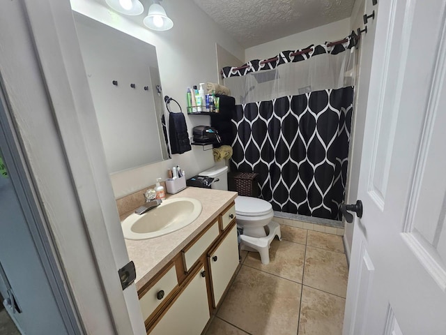 bathroom featuring curtained shower, toilet, vanity, a textured ceiling, and tile patterned floors