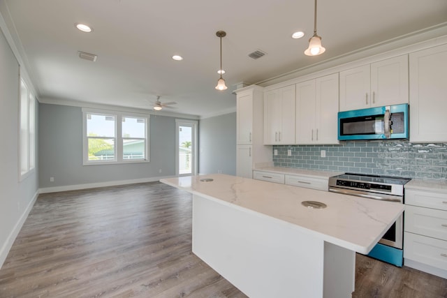 622 Diane Ave, Little Torch, FL 33042 - kitchen with appliances with stainless steel finishes, ornamental molding, backsplash, open floor plan, and a center island