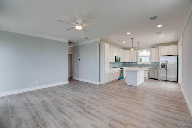 622 Diane Ave, Little Torch, FL 33042 - kitchen featuring appliances with stainless steel finishes, ornamental molding, open floor plan, light countertops, and tasteful backsplash