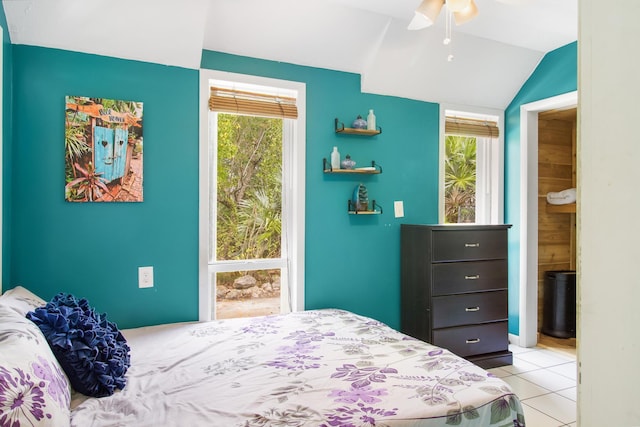 bedroom with vaulted ceiling, a ceiling fan, and light tile patterned flooring