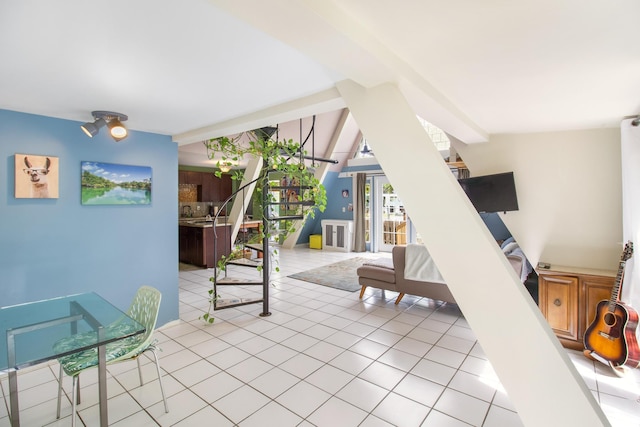 living room featuring lofted ceiling with beams and light tile patterned floors