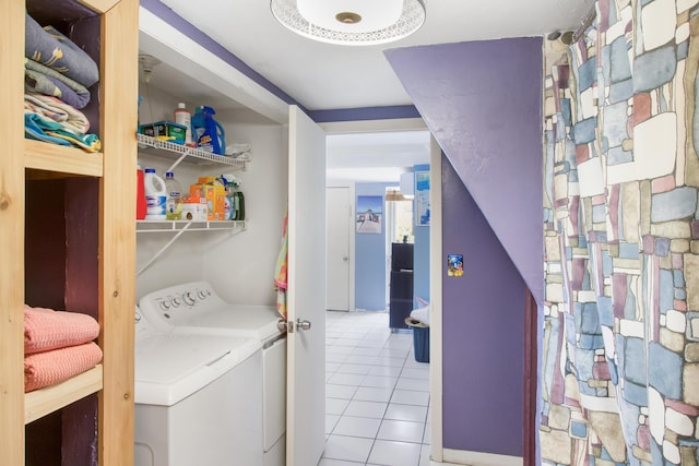 laundry room with washer and dryer, laundry area, and light tile patterned floors