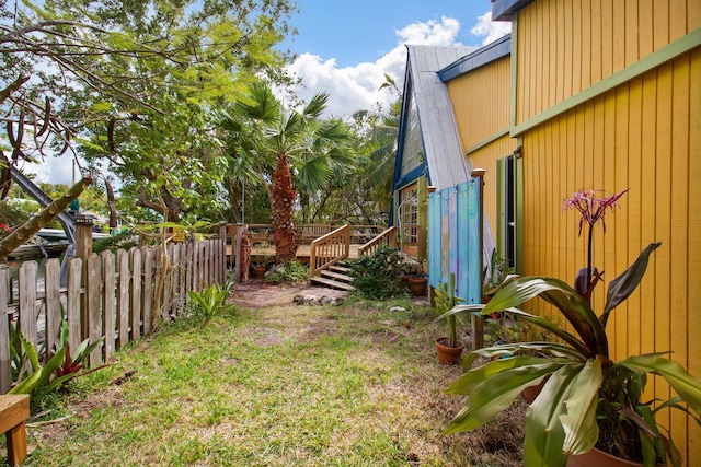 view of yard featuring fence and a wooden deck