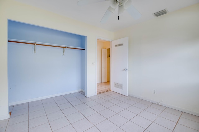 unfurnished bedroom with a closet, baseboards, visible vents, and a ceiling fan