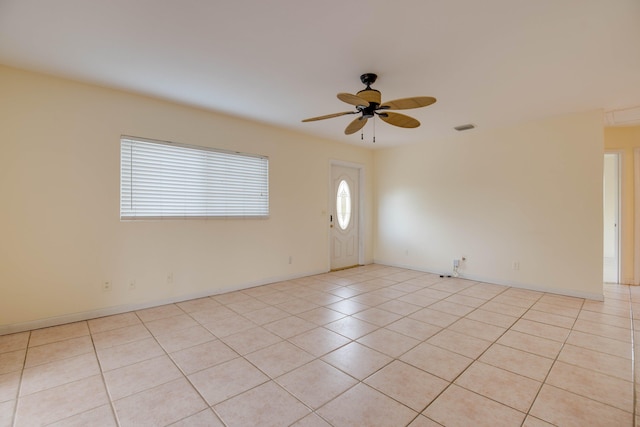 interior space featuring a ceiling fan, light tile patterned floors, and visible vents
