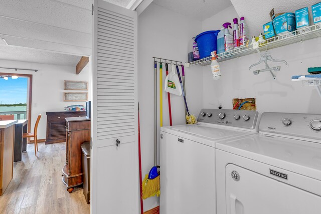 clothes washing area with laundry area, light wood finished floors, and independent washer and dryer