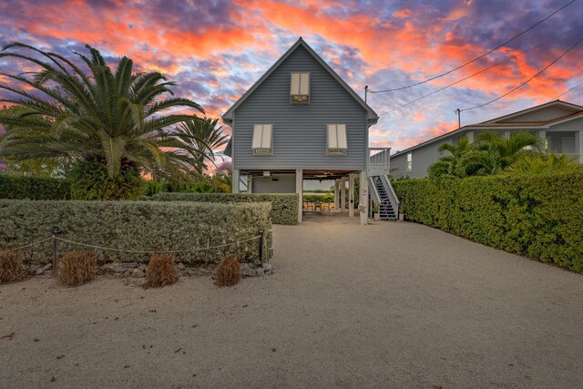 view of front of home with driveway, stairway, and a carport