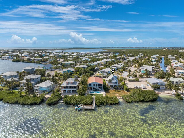 birds eye view of property featuring a water view and a residential view