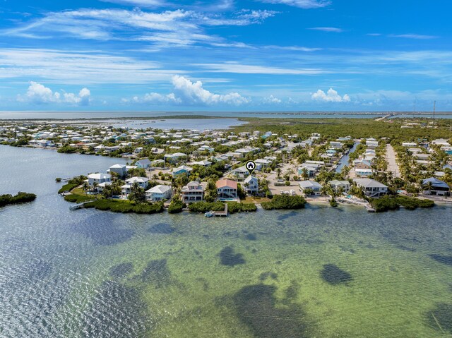 drone / aerial view with a residential view and a water view