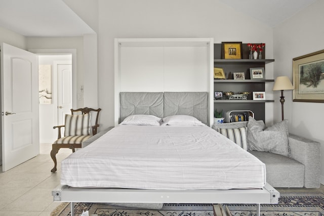 bedroom with light tile patterned flooring and vaulted ceiling