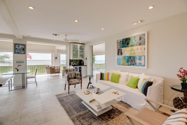 living area with light tile patterned floors, ceiling fan, visible vents, and recessed lighting