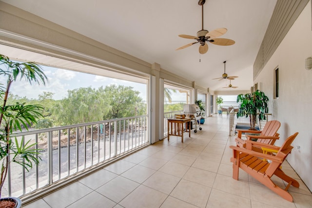 interior space featuring a balcony and a ceiling fan