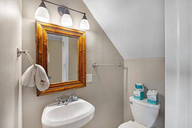 6005 Marina Villa Dr Unit C-019, Duck, FL 33050 - bathroom featuring a sink, vaulted ceiling, and toilet