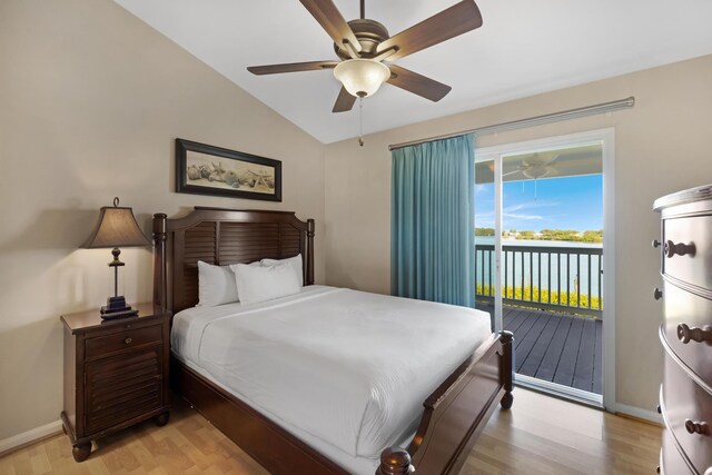 6005 Marina Villa Dr Unit C-019, Duck, FL 33050 - bedroom with light wood finished floors, access to exterior, vaulted ceiling, baseboards, and a water view