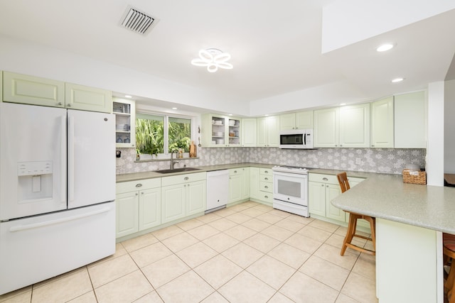 661 12th St, Key Colony, FL 33051 - kitchen featuring white appliances, a sink, a peninsula, backsplash, and light tile patterned flooring