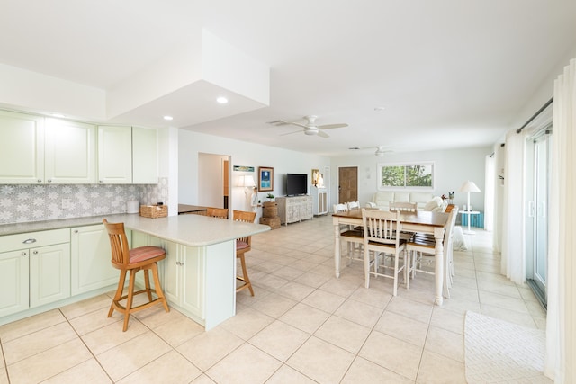 661 12th St, Key Colony, FL 33051 - kitchen featuring a breakfast bar, open floor plan, a ceiling fan, light tile patterned flooring, and light countertops