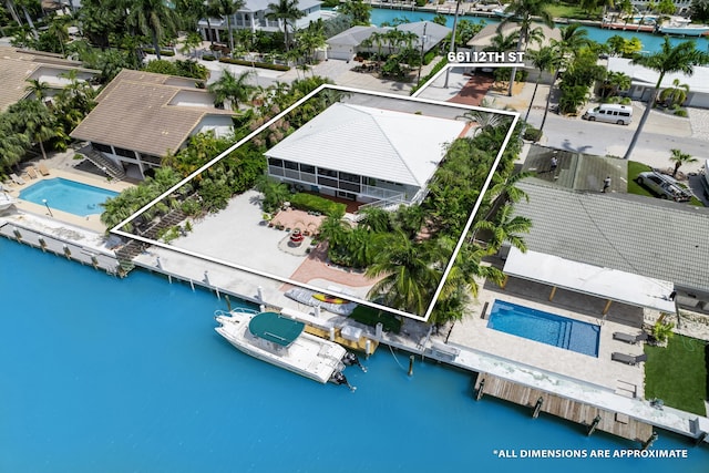 661 12th St, Key Colony, FL 33051 - aerial view of residential area with property boundaries highlighted, a nearby body of water, and a pool