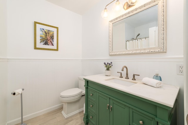 661 12th St, Key Colony, FL 33051 - full bath with wood finished floors, toilet, vanity, wainscoting, and a shower with shower curtain