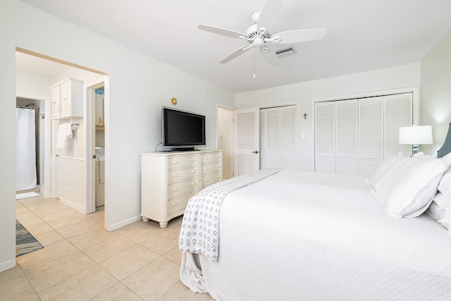 661 12th St, Key Colony, FL 33051 - bedroom with multiple closets, light tile patterned flooring, washer / clothes dryer, baseboards, and ceiling fan
