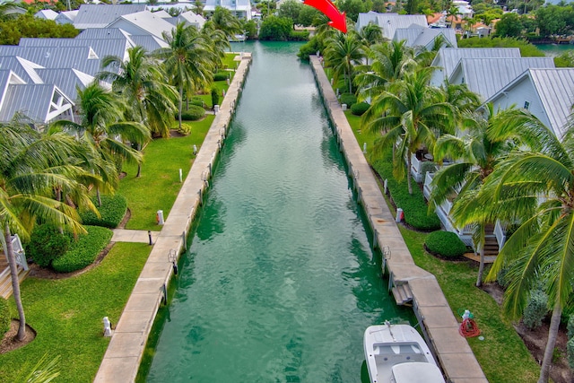 view of swimming pool featuring a residential view, a water view, and a lawn