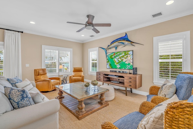 living room featuring visible vents, crown molding, baseboards, carpet flooring, and a ceiling fan