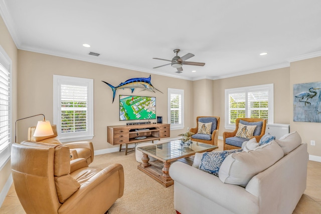 living area with baseboards, visible vents, a wealth of natural light, and ornamental molding