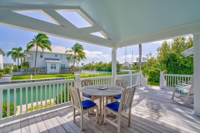 wooden deck featuring outdoor dining area and a residential view