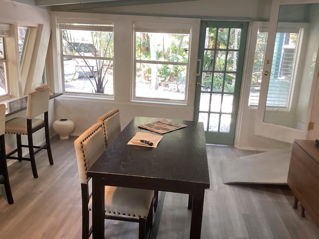 dining area with light wood-type flooring and baseboards